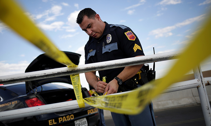 A police officer secures the area with a police cordon after a mass shooting at a Walmart in El Paso, Texas, on Aug. 3, 2019.