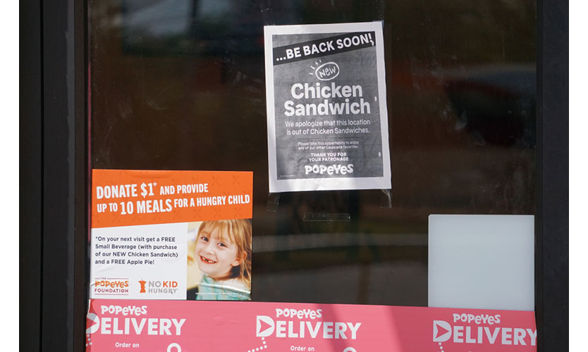 A Popeye's Restaurant posts sign that it's sold out of its new chicken sandwich.