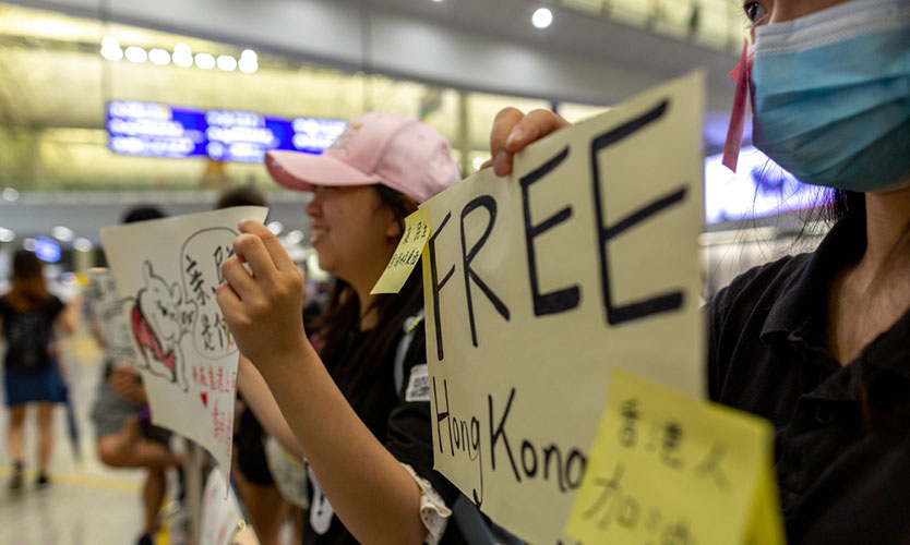 Protesters in the arrivals hall of Hong Kong International Airport