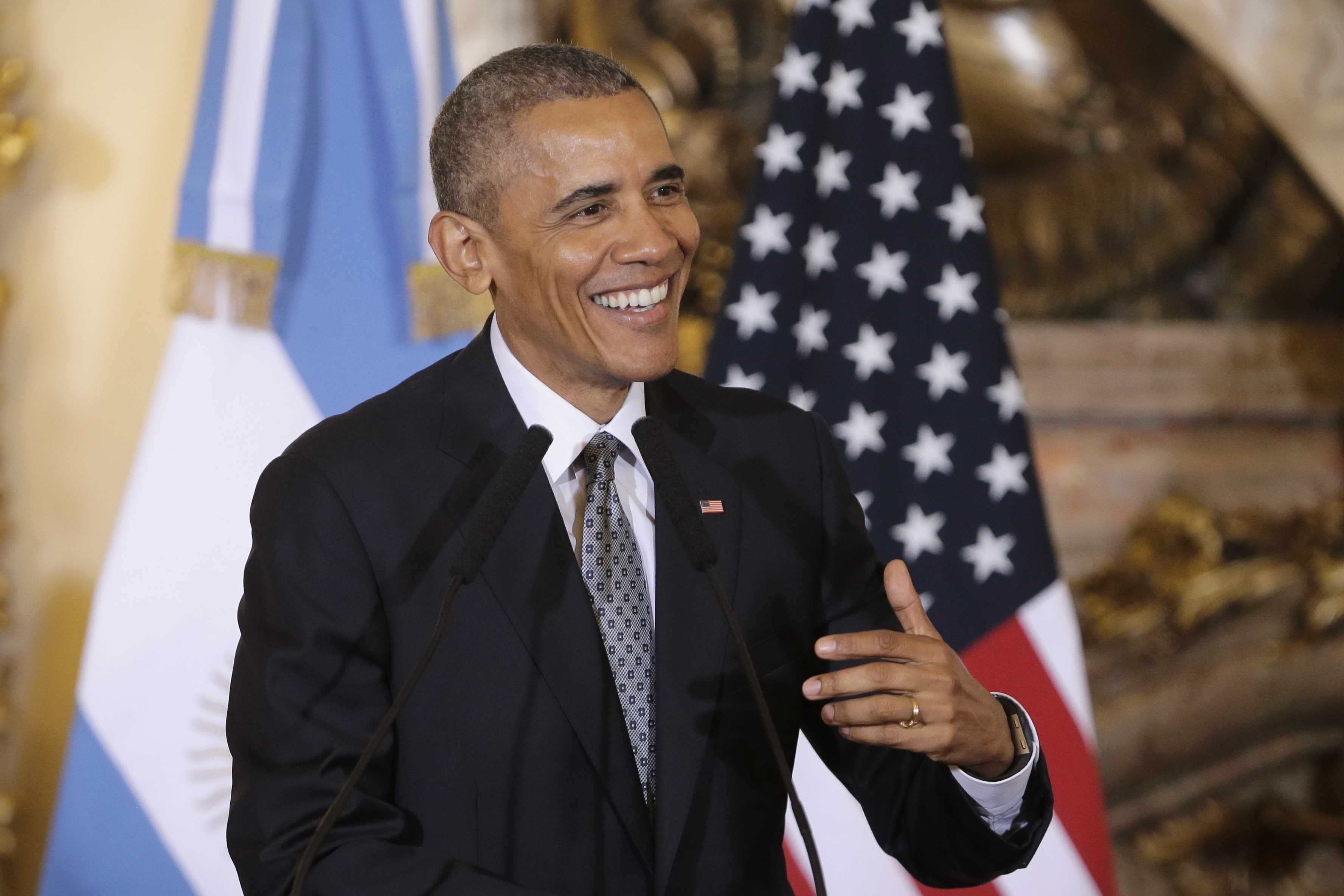 Obama praises health reform law's track record as future clouds