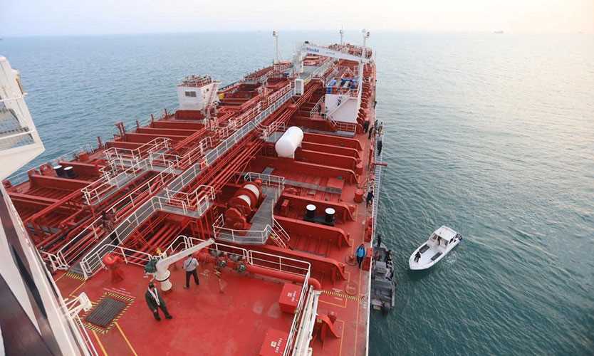 A boat of Iranian Revolutionary Guard is seen next to Stena Impero, a British-flagged vessel owned by Stena Bulk, at Bandar Abbas port, in this undated handout photo.