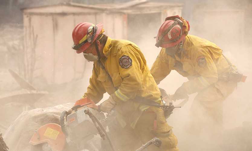 Cal Fire firefighters battle the Camp Fire blaze in Paradise, California.